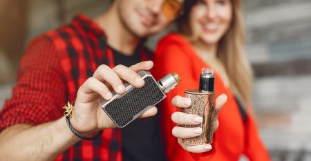 Stylish Young Couple With Vape In A City