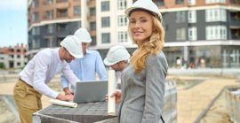 Woman With Drawing And Men With Laptop Behind Outdoors